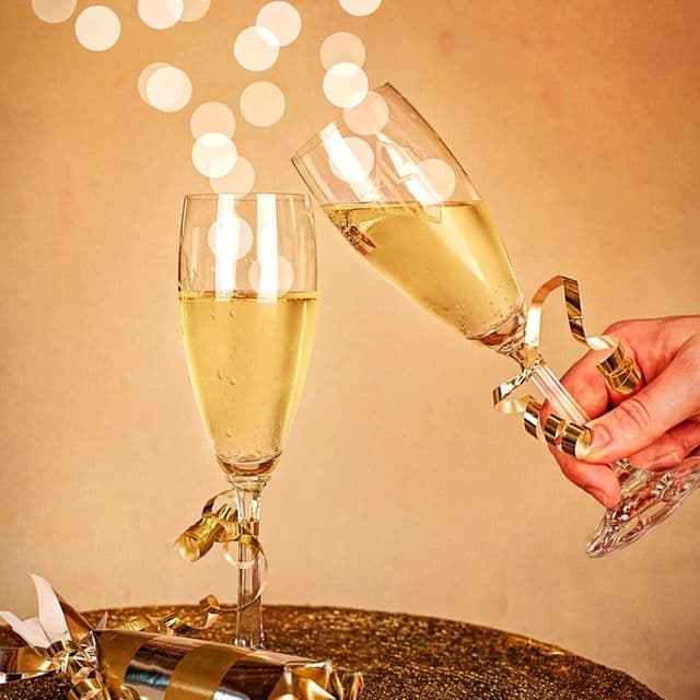 Champagne being poured into glasses in golden light
