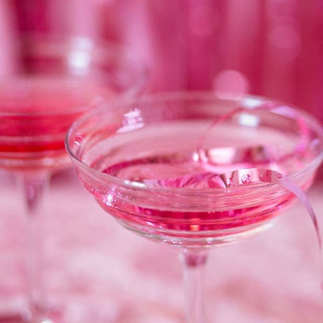 Pink cocktail coupes in bright rose light