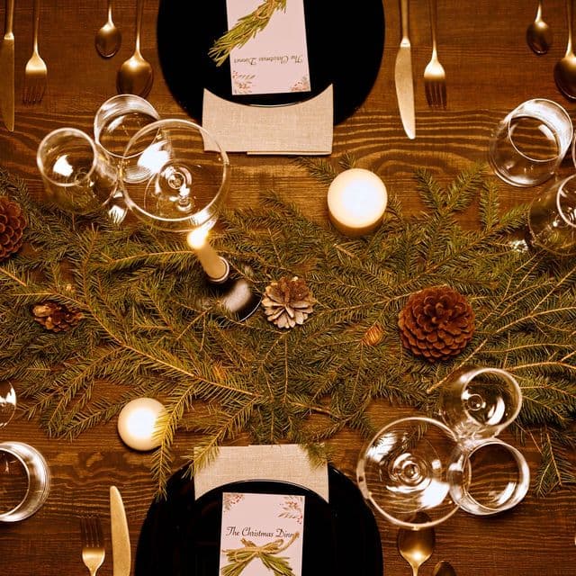 A Christmas flat lay with glass baubles and greenery
