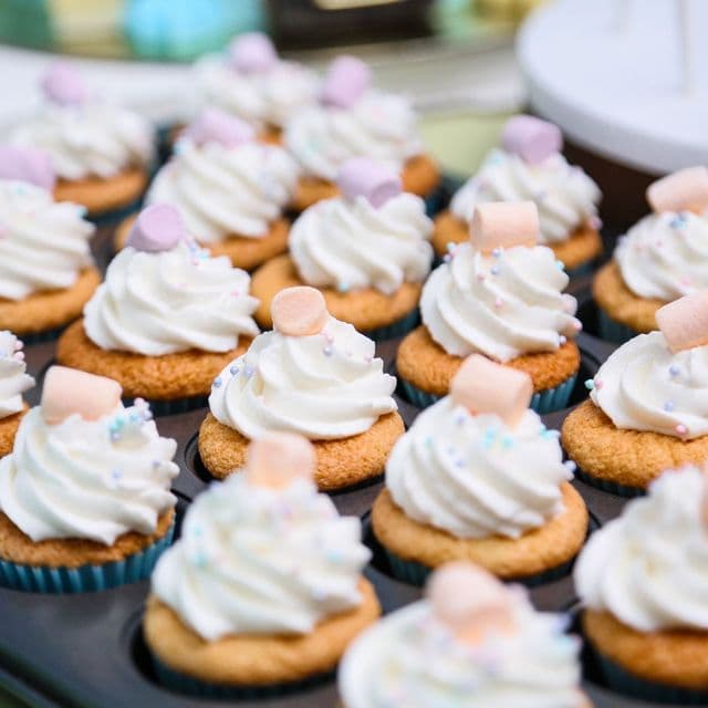 A tray of pastel marshmallow-topped mini cupcakes