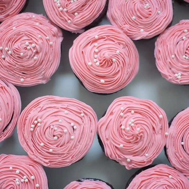 Pink rose-swirl cupcakes seen from above
