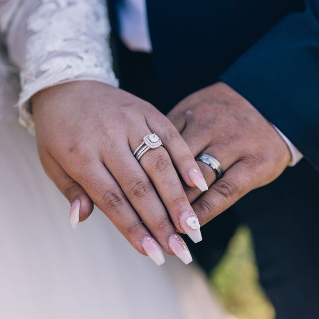 A couple’s hands showing their wedding rings