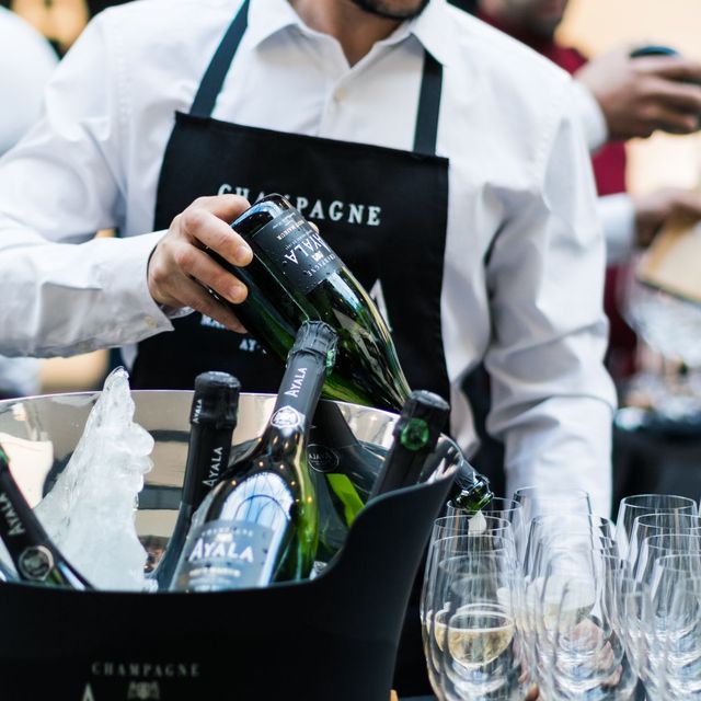 A sommelier opening champagne at a reception