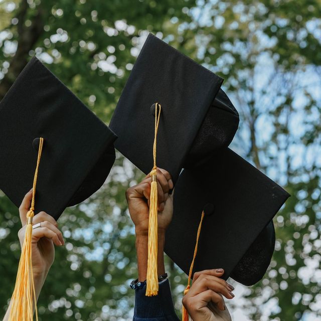 Graduation caps and tassels raised in the air